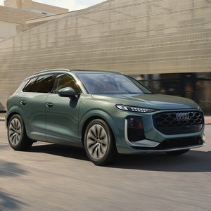 Side view of an Audi Q3 driving.